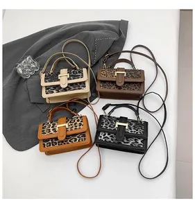 Detail of leopard print patchwork handbags with gold metal clasps and thin shoulder straps