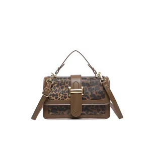 Retro leopard print shoulder bag with brown faux leather trim and gold metal buckle