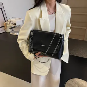 Large capacity black leather shoulder bag with silver chain strap for women commuters