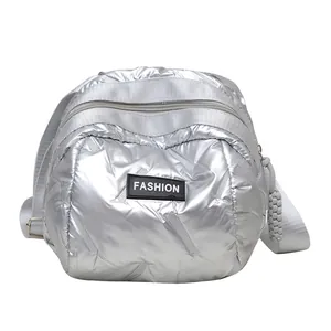 Chic silver quilted puffer shoulder bag in metallic space cotton with a fashion label