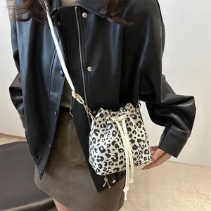 Trendy leopard print bucket bag with drawstring closure and white shoulder strap for women