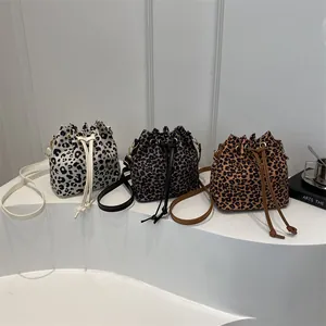 Leopard print drawstring bucket bag in three colors with adjustable shoulder straps