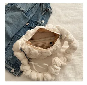 Detail view of the white plush pleated bag showing large capacity and zipper closure