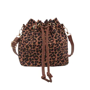 Trendy leopard print drawstring bucket bag with adjustable shoulder strap and gold hardware
