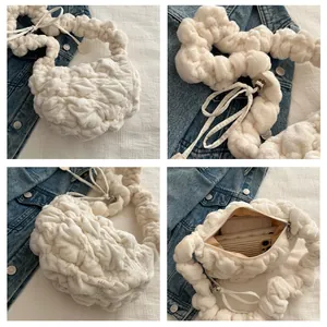 Close-up of white plush crossbody bag with quilted bubble texture and zipper detail