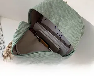 Detail view of corduroy backpack interior showing large storage space and zipper closure