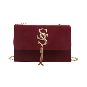 Retro burgundy suede crossbody bag with gold S-logo, tassel detail and chain strap