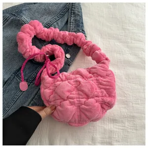 Detail of bright pink plush bag with pleated texture and soft ruffled top handle