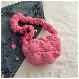 Detail of pink ruched plush handbag showing soft texture and stylish cloud design