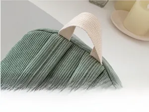 Close-up of Morandi green corduroy backpack showing comfortable off-white woven handle