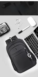 Detailed close-up of a black waterproof nylon backpack with multi-layer storage and metal logo