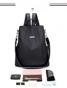 Black nylon anti-theft backpack showing spacious interior for cosmetics and accessories