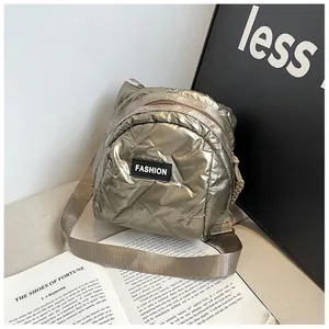 Champagne gold puffer crossbody bag with quilted finish and adjustable shoulder strap