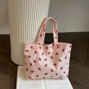 Pink corduroy tote bag with strawberry print and double handles for casual daily use