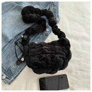 Close-up of black plush pleated cloud bag with soft textured scrunchie shoulder strap