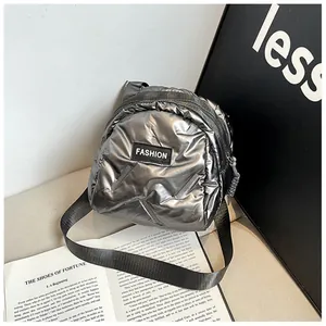 Chic silver quilted puffer crossbody bag with fashion logo and adjustable strap