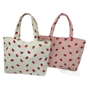 Corduroy strawberry tote bags in cream and pink colors with double top handles