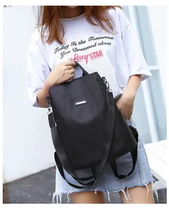 Detail of high-density nylon anti-theft backpack with silver metal logo and side pocket