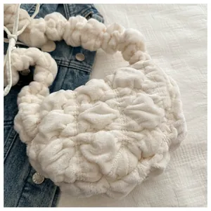 Detail of plush off-white shoulder bag with popcorn texture and soft pleated fabric