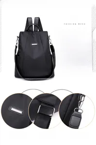 Detail of high-gloss hardware buckle and adjustable strap hooks on black nylon backpack