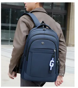 Detail of navy blue water-resistant backpack with S-logo and TOP MADE letter charm accessory