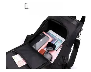 Spacious interior of black nylon anti-theft backpack showing tablets and phone