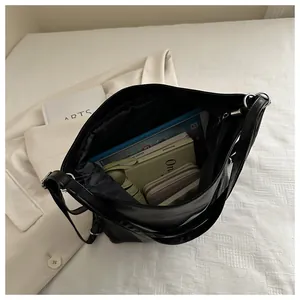 Interior view of black tote bag showing capacity with laptop and daily essentials