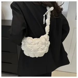 Detail of white popcorn textured quilted shoulder bag showing the plush knit material