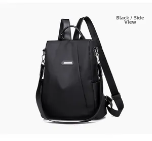 Detail view of black anti-theft nylon backpack featuring side pockets and metal logo tag