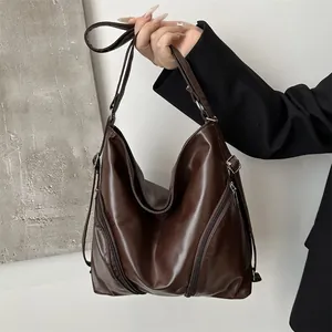 Minimalist soft PU leather tote bag in dark brown with decorative zippers and adjustable strap