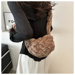 Detail of pleated plush shoulder bag in brown fabric featuring a soft ruffled texture