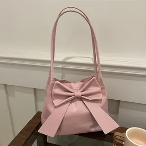 Chic pink bow shoulder bag with dual straps and spacious bucket shape for women