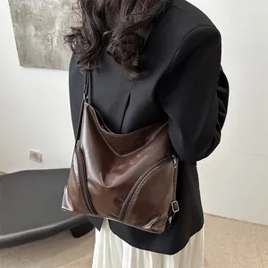 Deep brown soft leather tote bag for women showing convertible backpack straps on a model