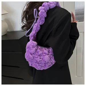 Detail of plush lilac pleated shoulder bag showing soft fuzzy texture on a model