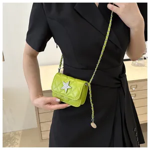 Lime green quilted crossbody bag with silver rhinestone star detail on black suit