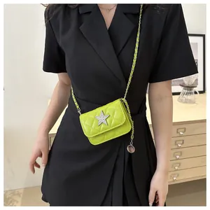 Model showcasing neon green quilted crossbody bag with rhinestone star and chain strap