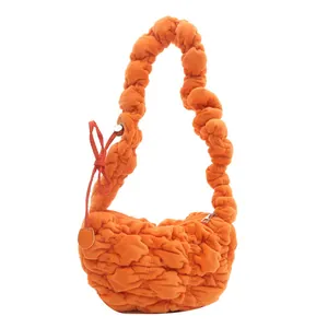 Orange pleated fleece shoulder bag with soft cloud texture and matching thick strap