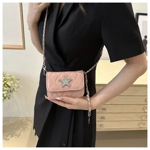 Detailed view of pink quilted leather texture with shimmering star emblem on shoulder bag