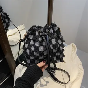 2025 trendy black and white checkered bucket bag with tassel fringe and drawstring closure