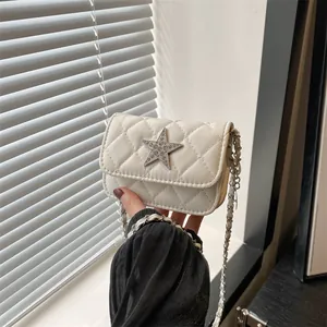 Stylish white quilted mini crossbody bag with a sparkling star buckle and chain strap