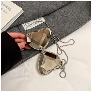 Silver heart-shaped acrylic evening clutch bag with metallic facets and chain strap