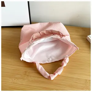 Detail showing pink waffle fabric texture with metal snap button and silk lining
