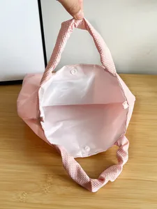 Pink bubble texture handbag with pearl chain bow pattern and secure button closure