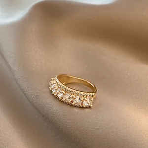 Classic gold-plated ring featuring round-cut cubic zirconia on champagne silk backdrop