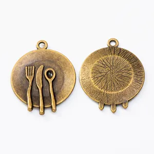 Macro detail of bronze alloy cutlery pendant showing embossed fork and knife textures
