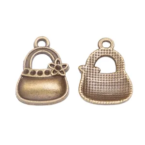 Detailed close-up of vintage bronze alloy handbag charms with floral patterns and textures