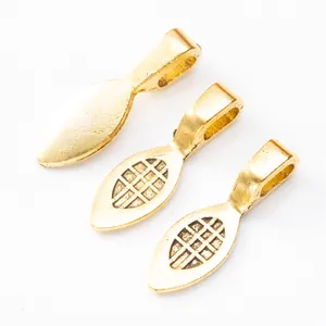 Detail view of gold vintage zinc alloy spade pendant clasps with grid texture