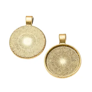 Close-up of golden 25mm round alloy bezel pendants with radial texture for DIY jewelry