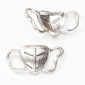 Detailed close-up of retro silver zinc alloy N95 mask charms for DIY jewelry making