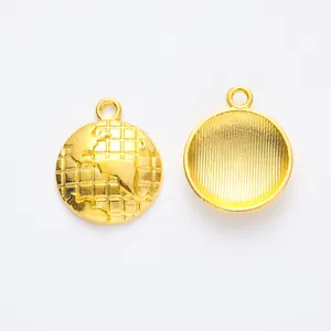 Detail of round golden alloy globe pendants with embossed maps and textured back